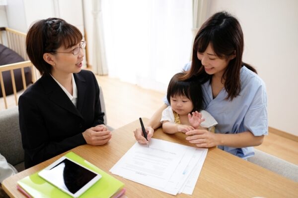 Woman and child signing paperwork