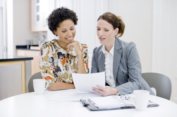 Two women reviewing paperwork